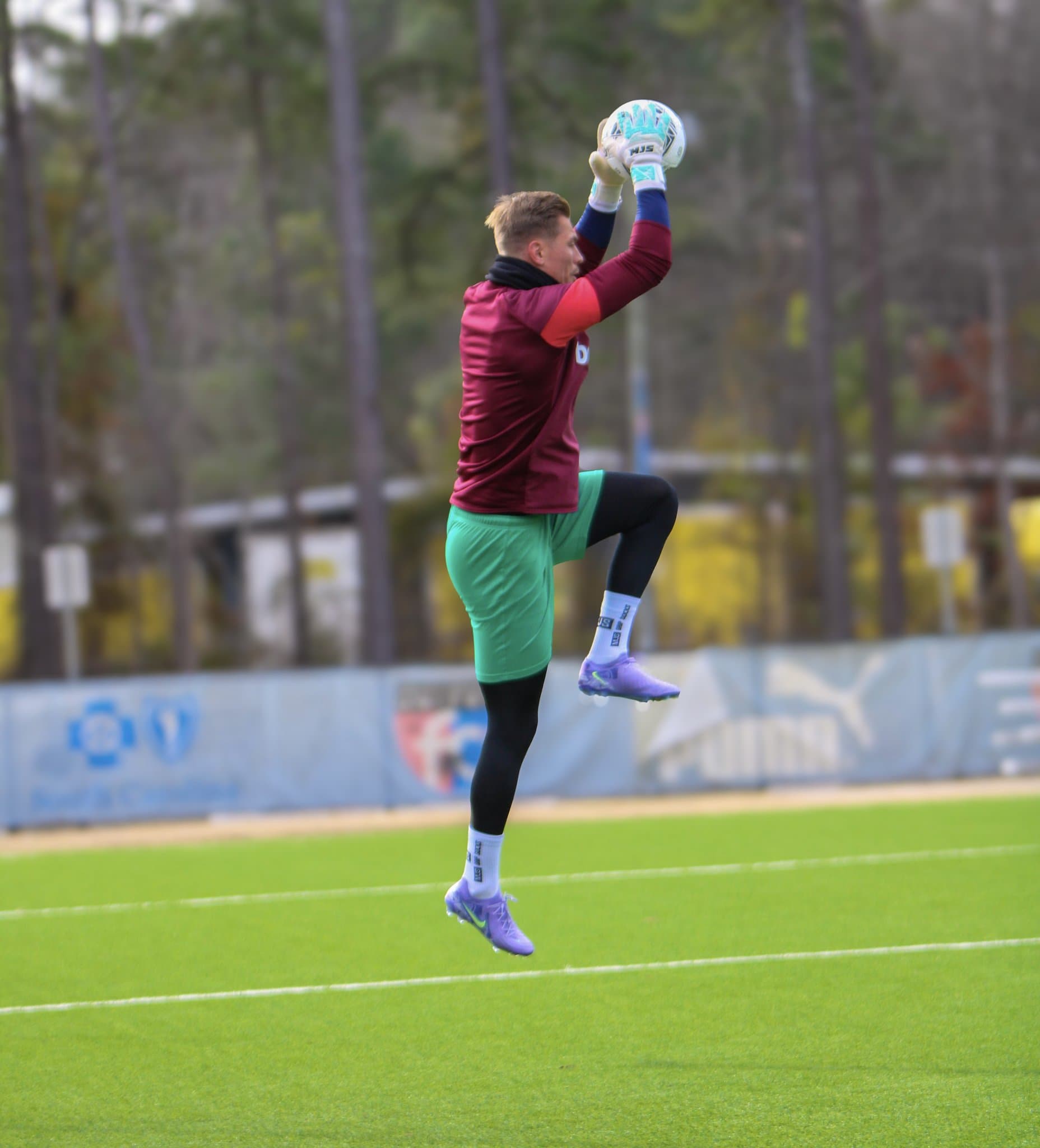 TECCE goalkeeper leaping to catch the ball